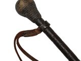 a close up of a walking stick with a leather handle