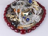 a picture of a pile of jewelry on a white surface