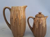 two brown vases sitting next to each other on a table