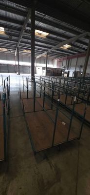 rows of empty tables in an empty warehouse with a lot of windows