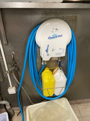 a blue hose attached to a white bucket
