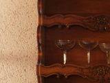 a wooden shelf with wine glasses on top of it