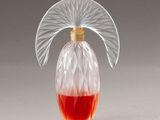 an image of a glass bottle with a red liquid in it