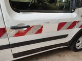 a white van with red and black stripes parked in a garage
