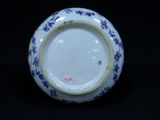 a blue and white vase with a blue flower design