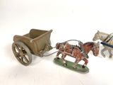 two figurines of horses pulling a carriage and a horse drawn carriage