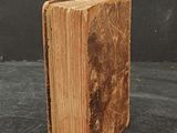 an old book with a piece of paper sticking out of it
