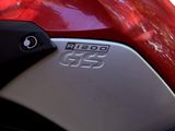 a close up of a red motorcycle parked on the street