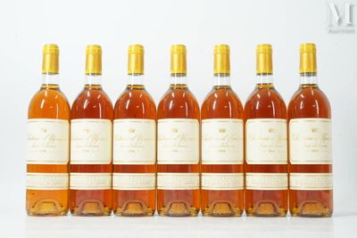six bottles of wine lined up in a row on a table