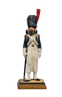 figurine of a soldier in uniform with a sword and hat