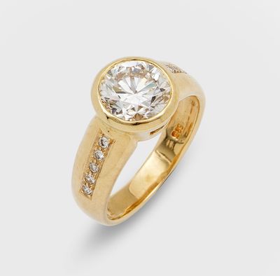 a gold ring with a round diamond surrounded by small diamonds