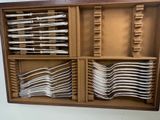 many forks and spoons in a wooden box