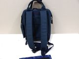 blue backpack on a white table with a blue bag next to it