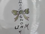 a white plate with writing on it with a bow on it