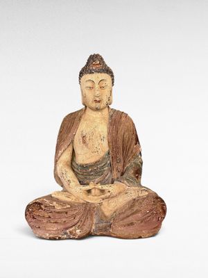 statue d'un Bouddha assis sur une surface blanche