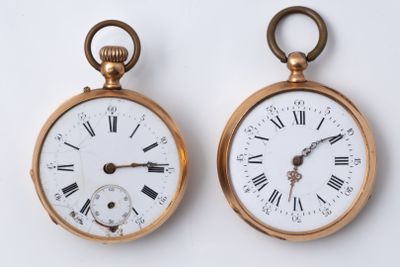 two clocks that have roman numerals on them