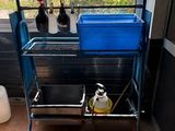 a blue cart with a blue container on top of it