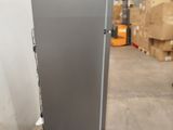 a refrigerator that is sitting on a pallet in a warehouse