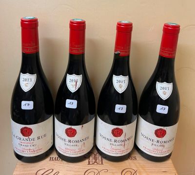 four bottles of wine are lined up on a wooden box