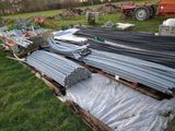 a pile of metal pipes on the ground in a field