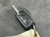 a car key and a piece of paper on the floor