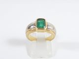 a picture of a ring with a green stone