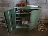 a green cabinet with a bunch of tools inside of it