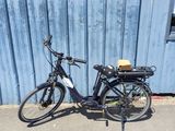 a bike that is parked in front of a blue wall