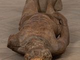a statue of a man laying on the floor
