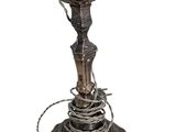 a metal lamp that is on top of a table