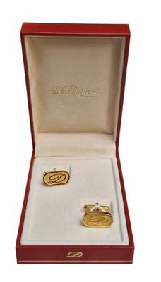une photo d'une paire de bagues de manchette dans un coffret rouge