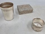 two silver cups and a silver box on a table