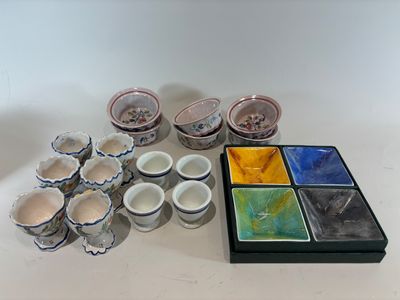 a lot of bowls and cups sitting on a table