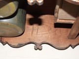 a close up of a wooden table with a vase on top of it