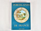 blue book with gold trim and a picture of a landscape on the cover