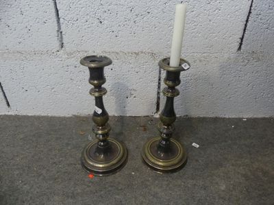 two candles that are sitting on the ground