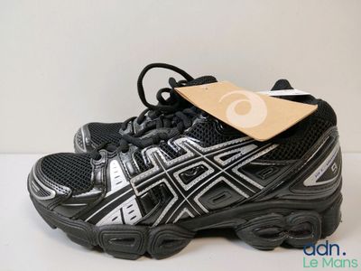 asics gel kayano running shoe with a tag on top of it