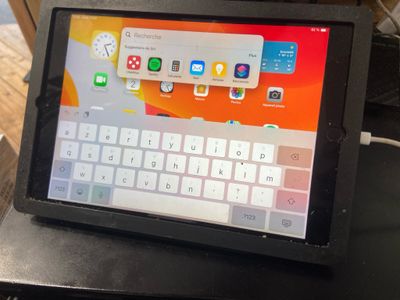 a tablet computer sitting on top of a black table