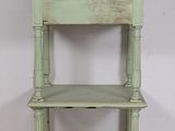 an image of a green shelf with a drawer on top of it