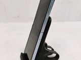 a cell phone that is on a stand on the table