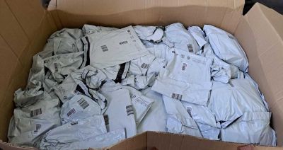 a cardboard box full of white shirts in it