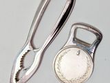 a silver bottle opener and a silver bottle opener next to each other
