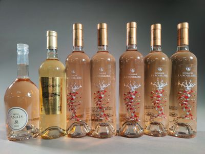 six bottles of wine are lined up in a row on a table