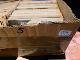 a cardboard box with a bunch of old records in it