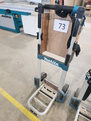 un diable avec une caisse dessus dans un entrepôt