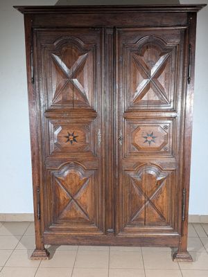 a wooden armoire with a star design on it