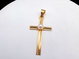 gold cross pendant with a pearl bead in the center