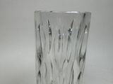 a glass vase with a pattern on it on a table