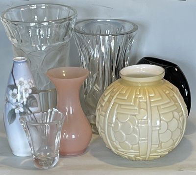 many different vases and glasses on a shelf