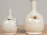 two vases that are sitting on a table